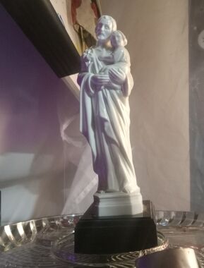 vintage religious figurine depicting Saint Joseph holding the Child Jesus,